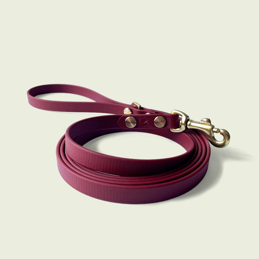 Elegant burgundy dog leash, 1/2 inch wide, with gold hardware and sturdy construction, perfect for stylish and durable walks.