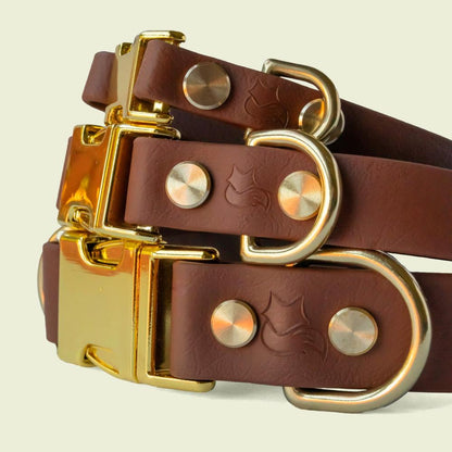 Stack of luxurious medium brown dog collars in 1/2, 3/4, and 1 inch wide, with gold hardware, showcasing premium style and durability.