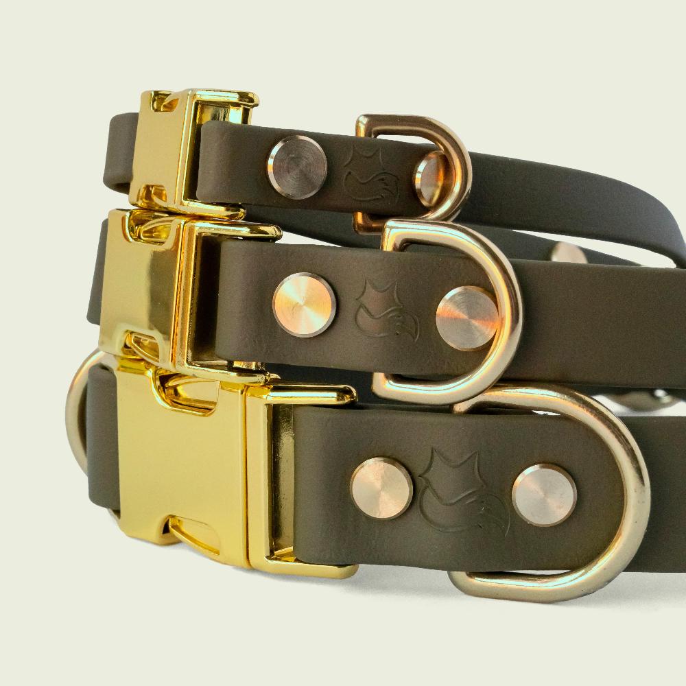 Stack of luxurious olive green dog collars in 1/2, 3/4, and 1 inch wide, with gold hardware, showcasing premium style and durability.